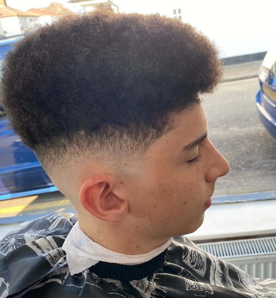 Curly top with skin fade haircut at Epic Barber, Woking